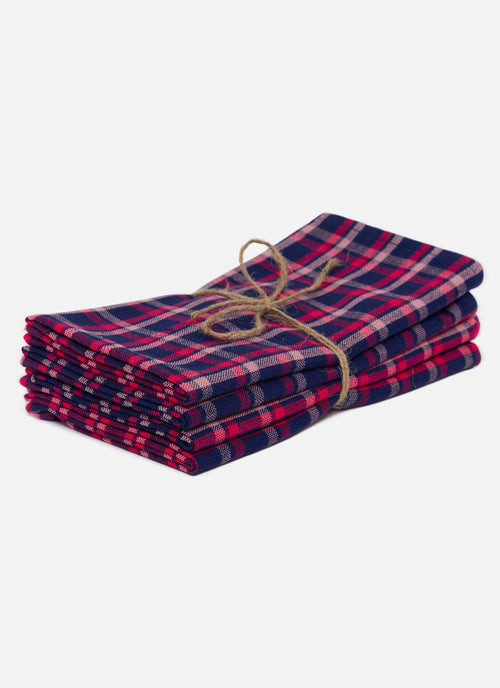Stack of red and blue plaid napkins tied with twine on a white background