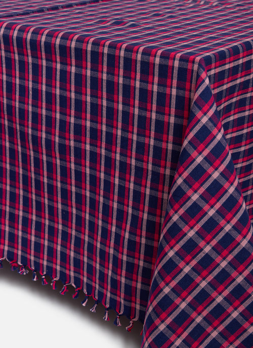 Plaid tablecloth with red and blue pattern on a white background