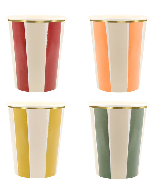 Four colorful striped cups with gold rims on a white background
