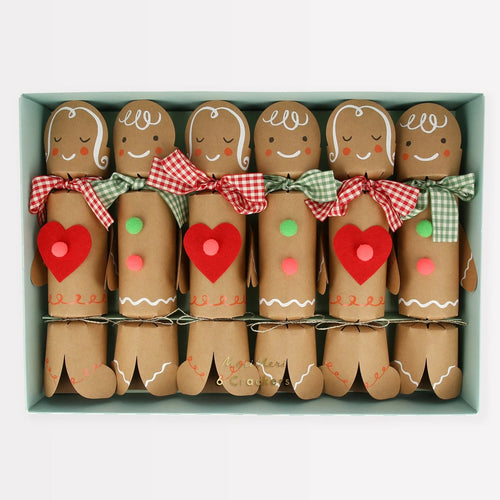 Set of gingerbread men figurines with decorative bows and hearts in a box