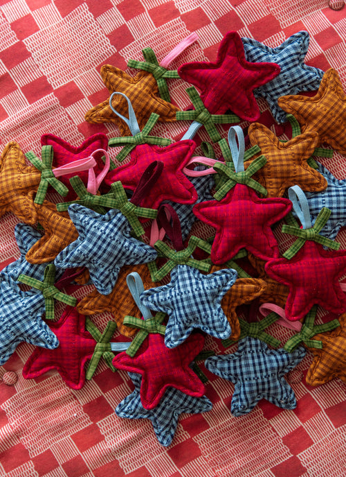Star Ornament Set laid out on ottoman