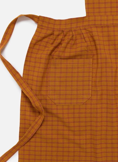 Orange checkered apron on a white background