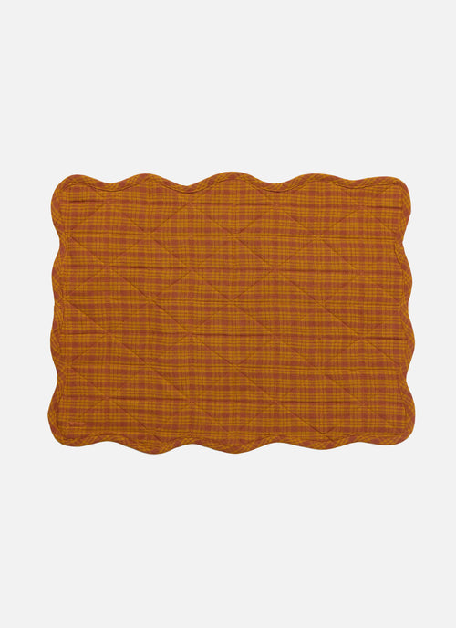 Rectangular placemat with scalloped edge in orange color on a white background