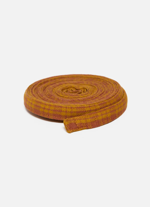Strip of orange and yellow striped fabric on a white background