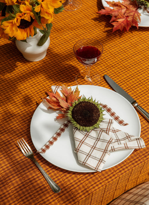 Table setting with sunflower decorations on a wooden table.