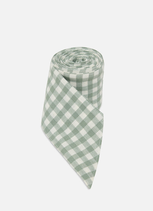 Green and white checkered fabric roll on a white background