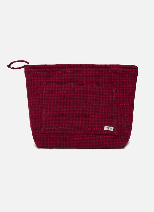 Red textured pouch with a brand label on a white background