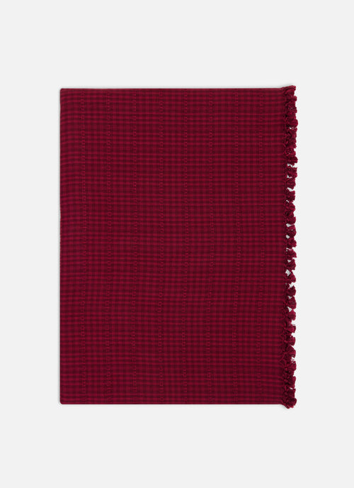 Red/Purple woven tablecloth folded on a white background