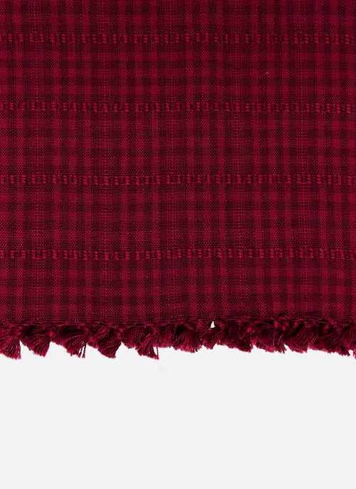Close-up of red fabric with a checkered pattern on a white background