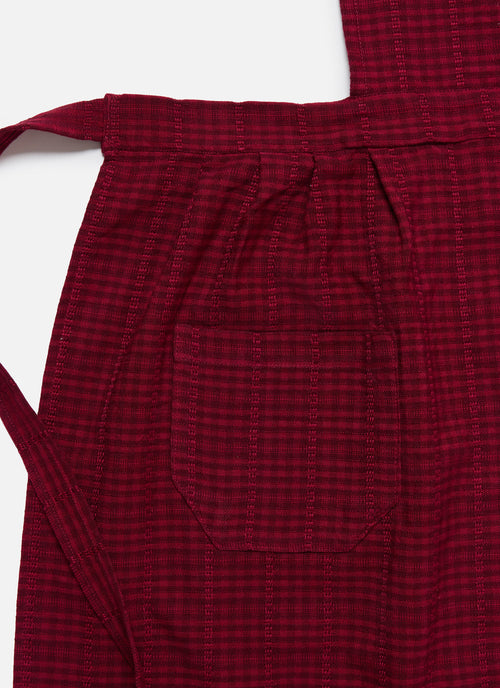 Red checkered apron on a white background closeup