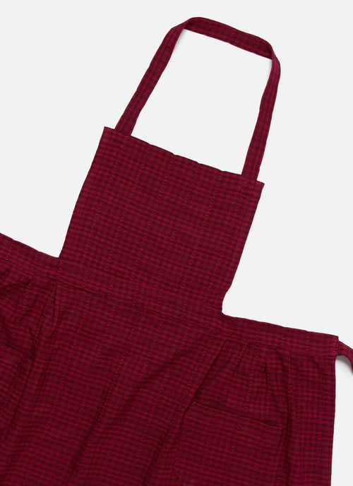 Red checkered apron on a white background closeup