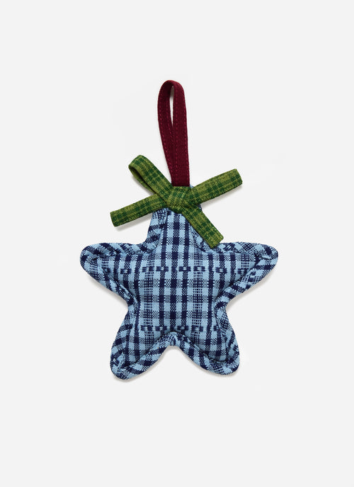 Blue checkered star-shaped ornament with a green ribbon on a white background